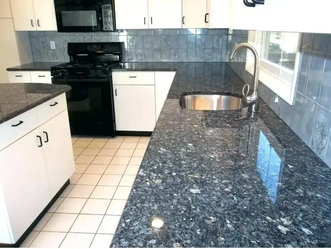 Dark patterned kitchen worktop around a sink