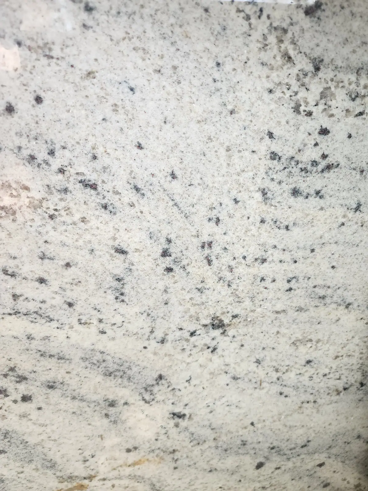 Close view of a light speckled stone-looking surface