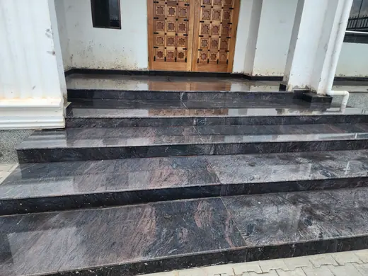 Dark stone steps leading to an entrance doorway
