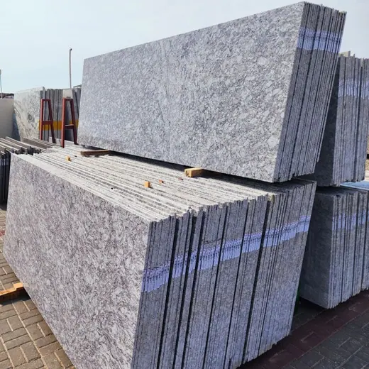 Cut pale speckled slabs stacked in rows