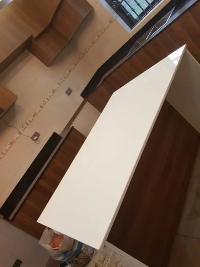 Stone piece positioned beside an interior staircase