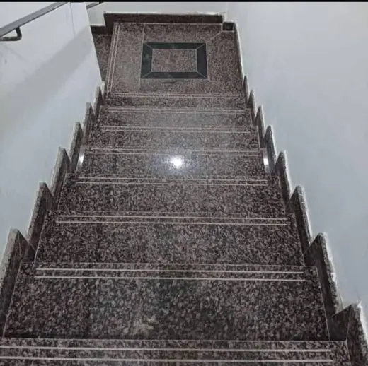 Polished dark staircase viewed from the bottom landing