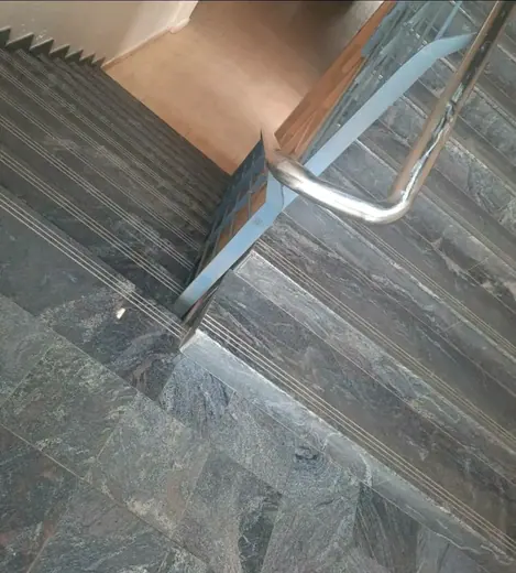 Dark stone stair edge and joint viewed closely
