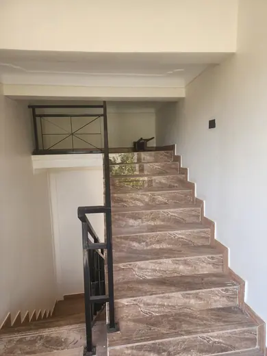Interior staircase with brown patterned treads