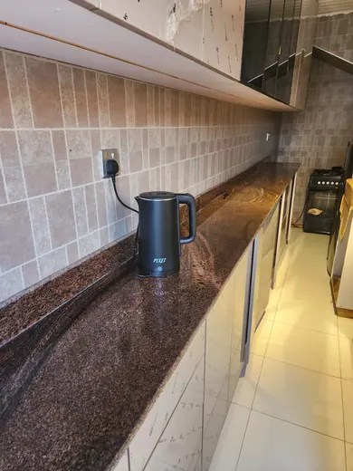 Brown patterned kitchen worktop close to a wall