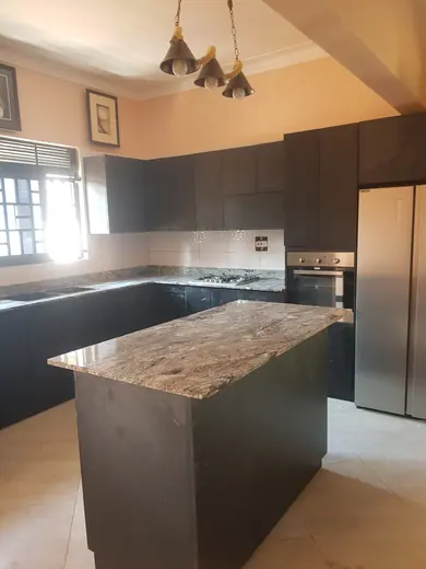 Patterned island surface in a kitchen with dark cabinetry