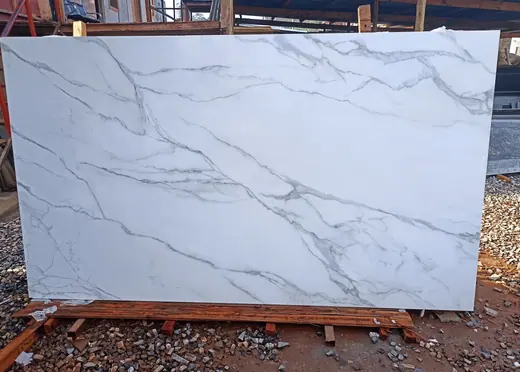 Large white slab with fine dark veins outdoors