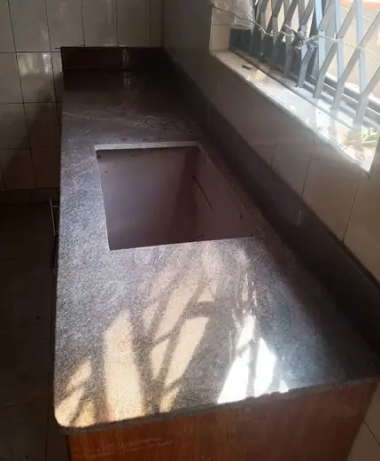 Deep stone-lined window recess in an unfinished room