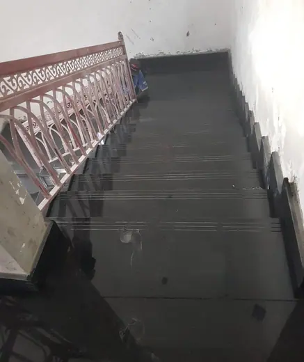 Dark staircase and metal railing during installation