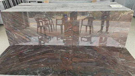 Glossy dark red patterned surface reflecting chairs