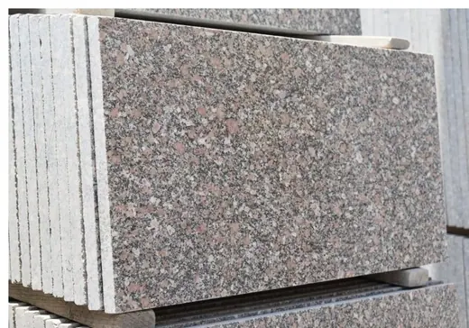 Pale speckled stone slabs stacked vertically