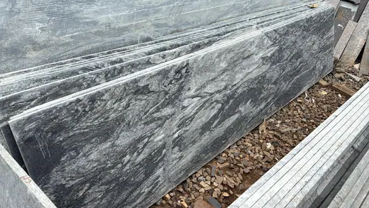 Close view of a dark veined stone step surface