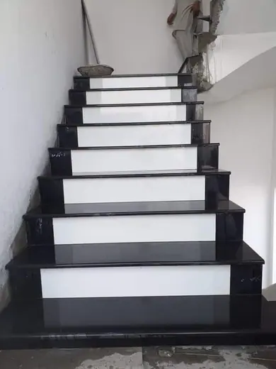 White staircase with dark stone treads