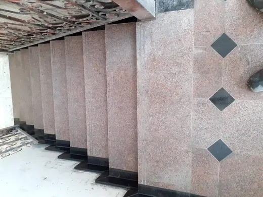 Outdoor staircase with light stone treads and patterned wall