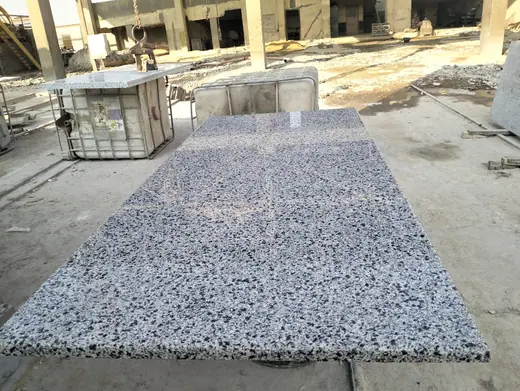 Speckled slab laid flat among other stock pieces