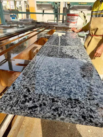 Roughly cut speckled slab on a workbench