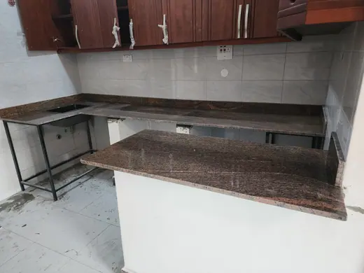 Brown patterned worktop across a kitchen island and rear counter
