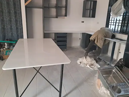 Pale stone piece resting on a workshop table
