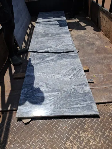 Long dark slab piece laid outside for handling