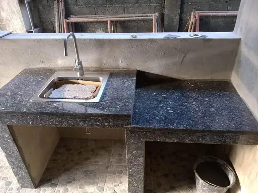 Dark counter with an inset sink at a work site