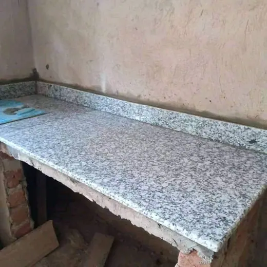 Speckled sill piece beneath a plastered wall