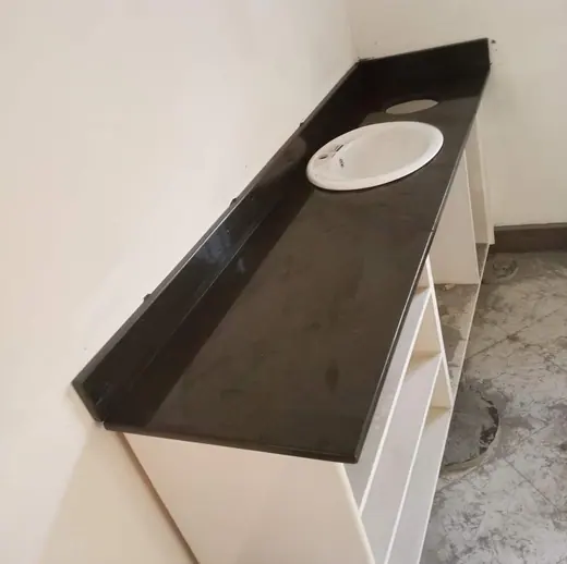 White basin set into a long brown vanity top