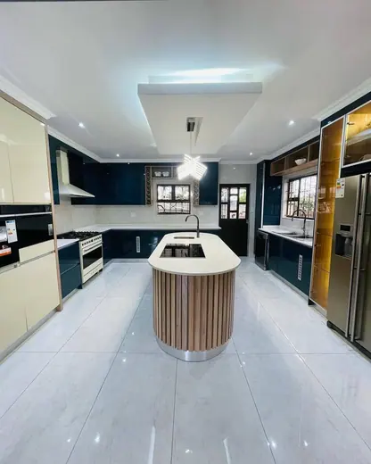 Bright kitchen with a light island surface and surrounding worktops