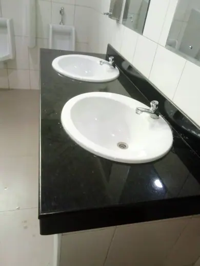 Round white basin on a polished dark vanity surface