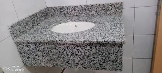 Oval basin opening cut into a speckled vanity surface