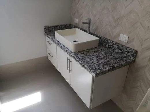 Square white basin over a speckled vanity top