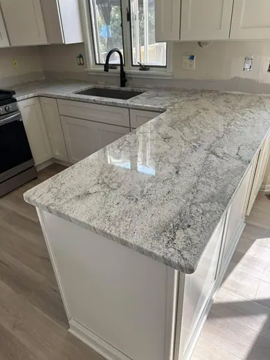 Pale patterned vanity surface beside a bathroom basin