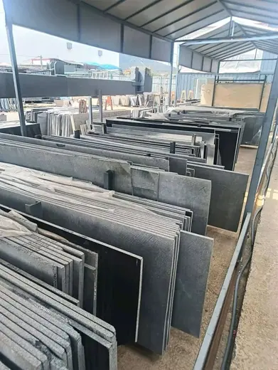 Stone slabs organised in racks at a yard