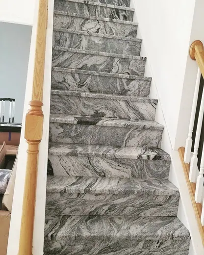 Light veined staircase with timber handrail