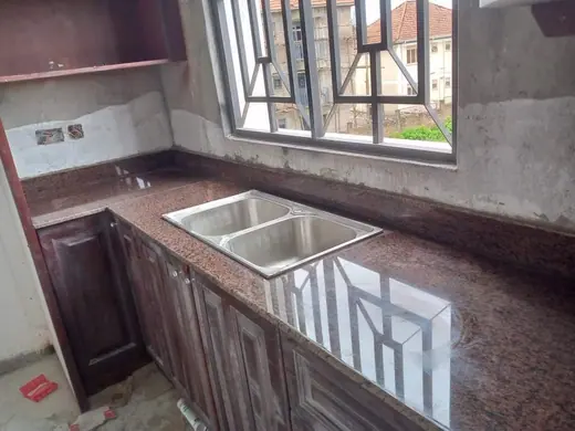 Kitchen worktop around two sinks beneath a window during installation