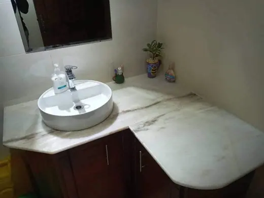 White vessel basin on a pale bathroom vanity surface