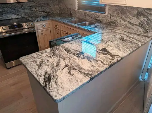 Boldly patterned kitchen worktop with a blue protective strip