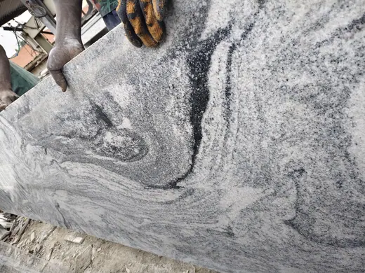 Swirling black and white veins across a stone surface